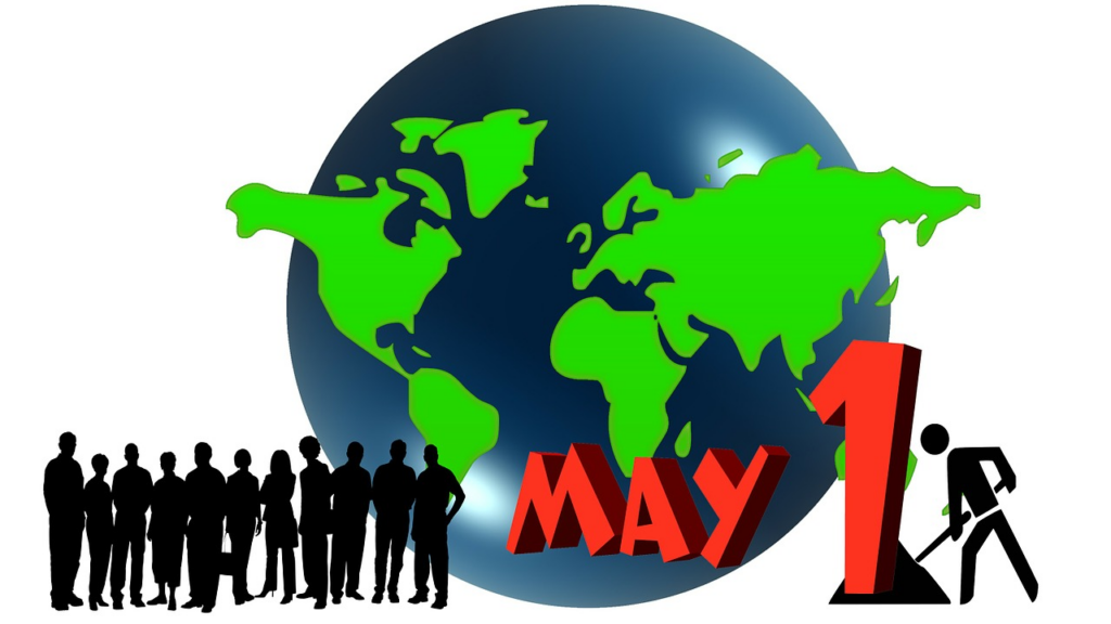Eine Weltkugel mit grünen Kontinenten, davor Siluetten von Menschen. Daneben der Schriftzug 'May 1'.